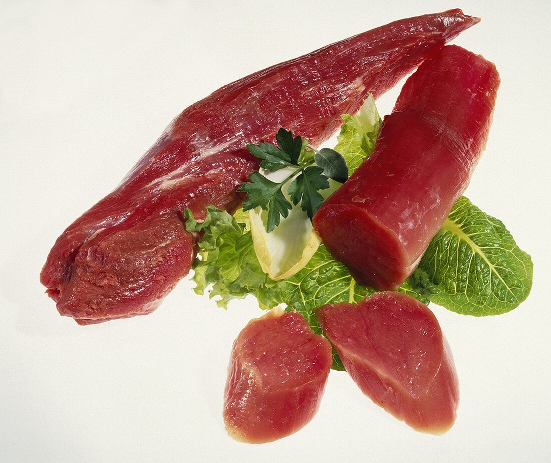 Raw pork fillet (whole and cut), lettuce leaves