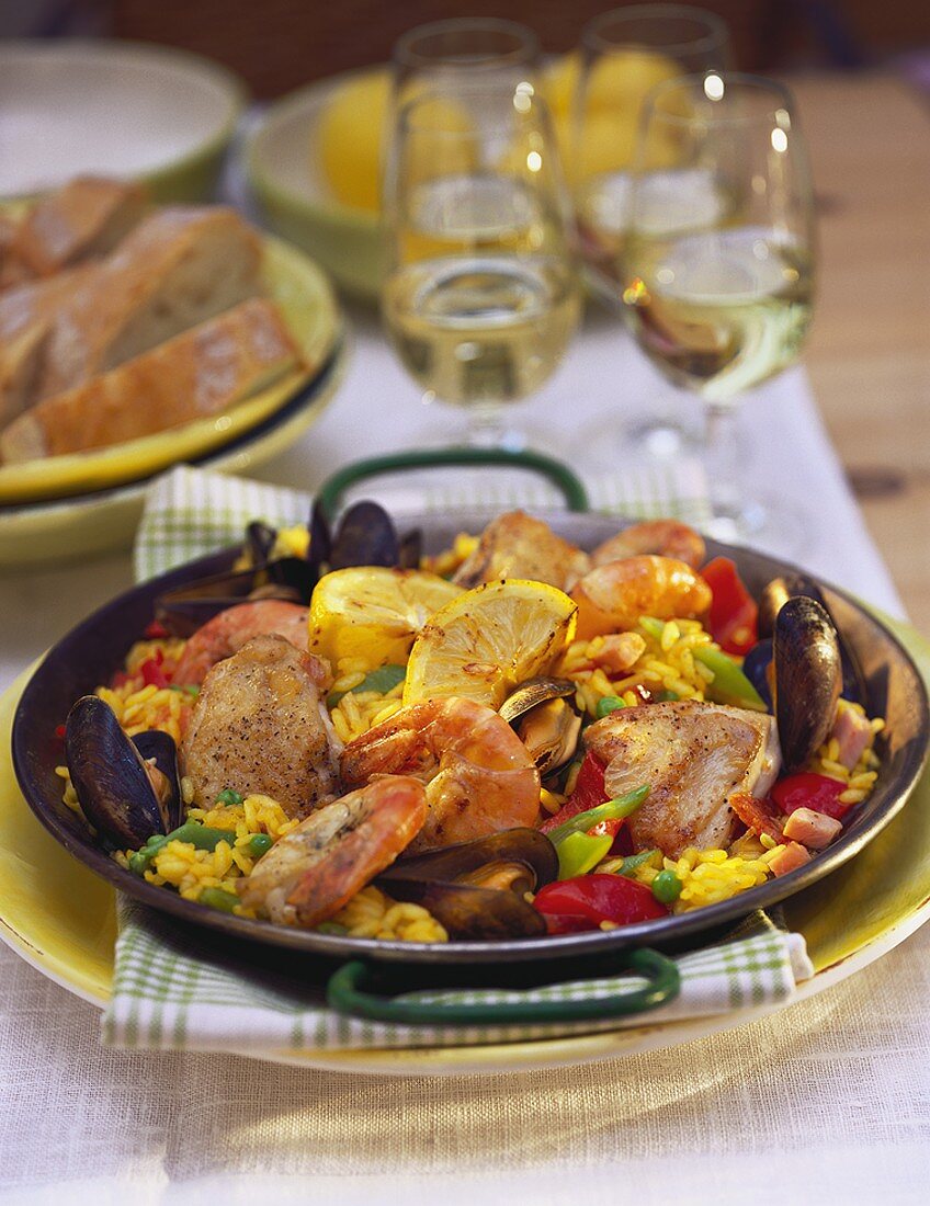 Classic paella in paella pan on laid table