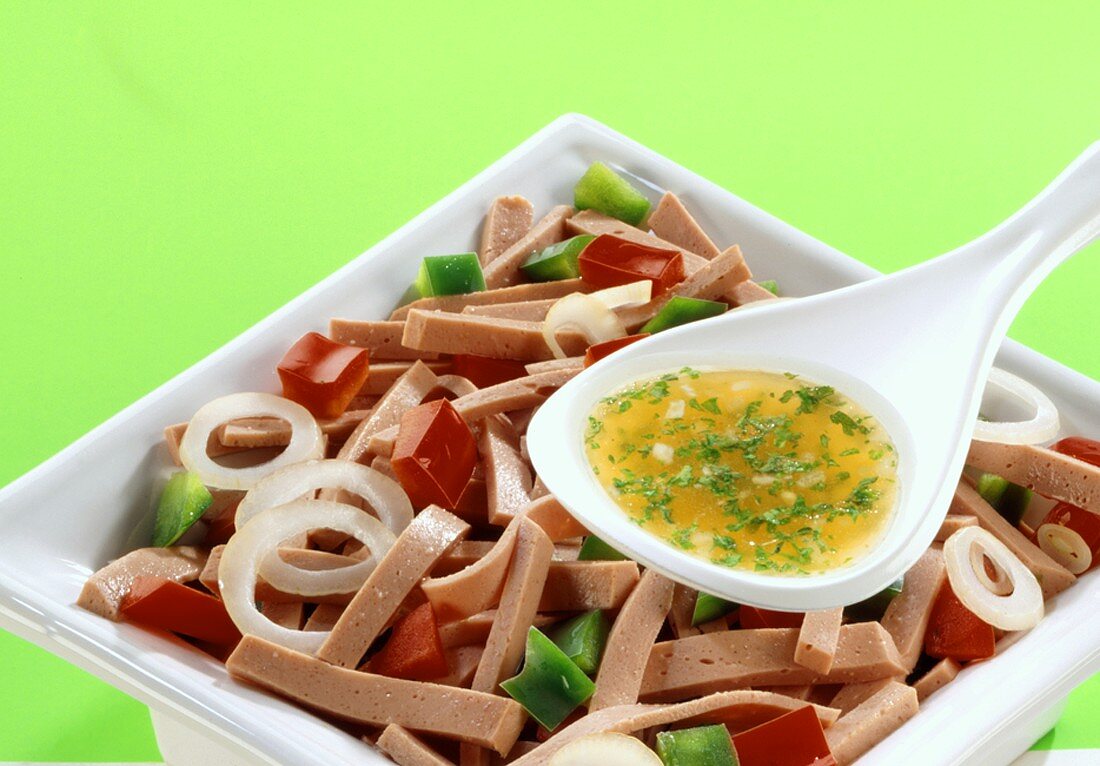 Sausage salad with peppers, onions and dressing