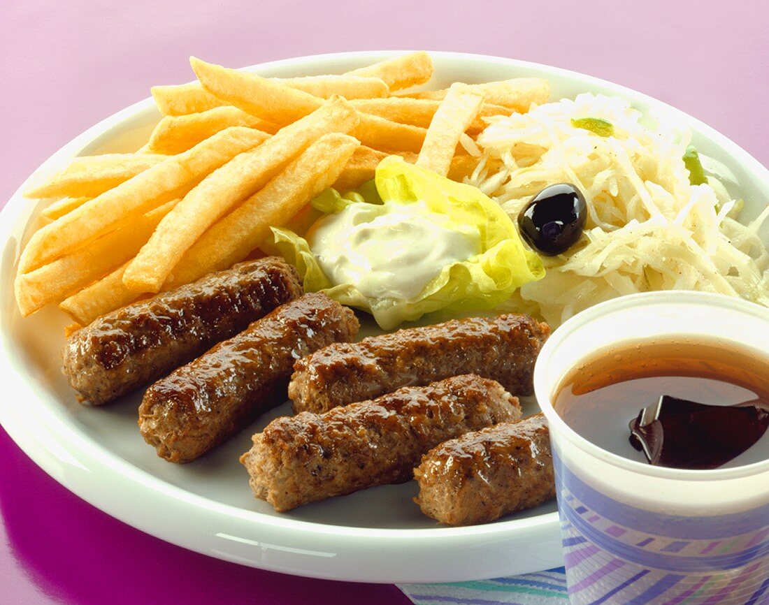 Cevapcici with chips, tzatziki and cabbage salad