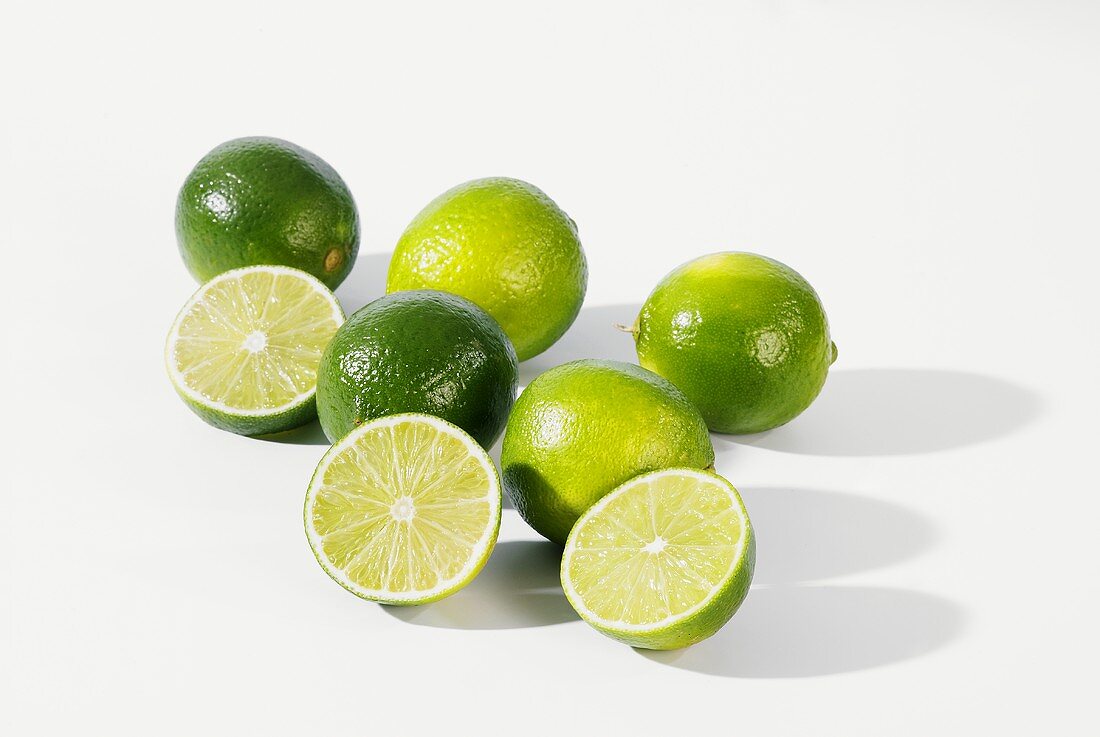 Several limes, whole and cut open