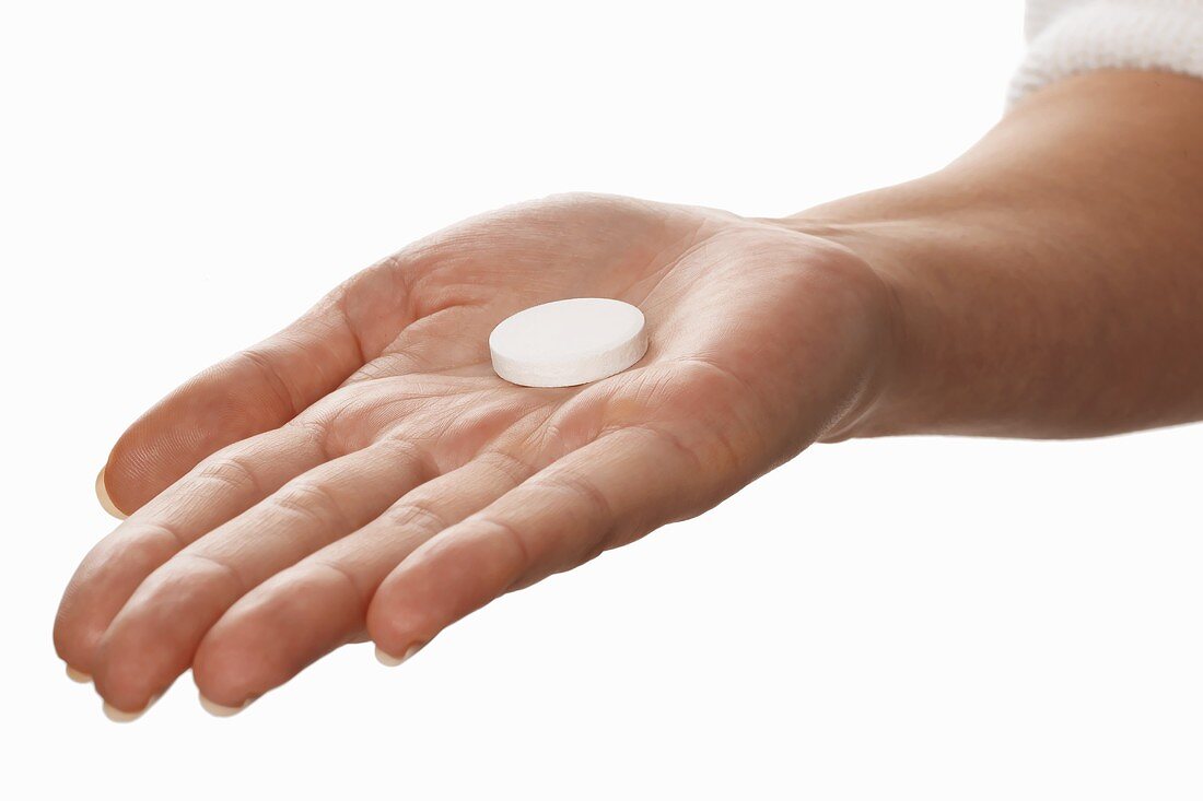 Vitamin tablet lying in someone’s hand