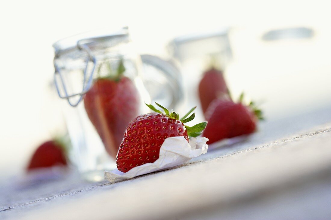 Fresh strawberries and preserving jars
