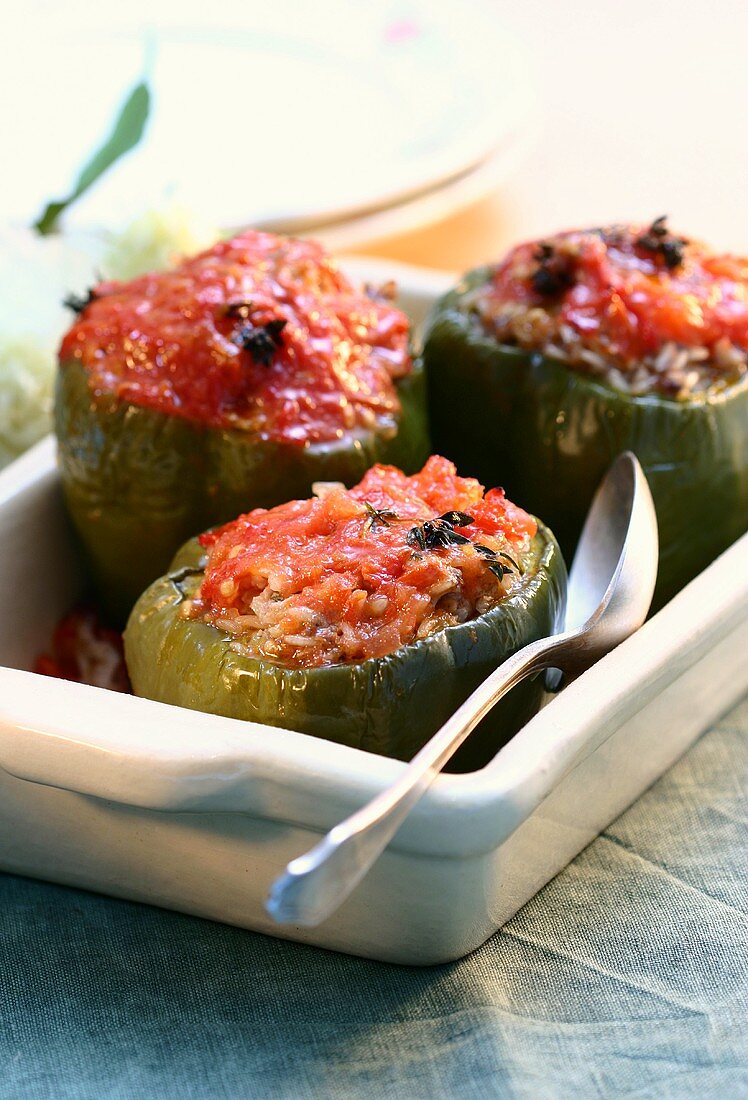Three peppers stuffed with tomatoes and rice