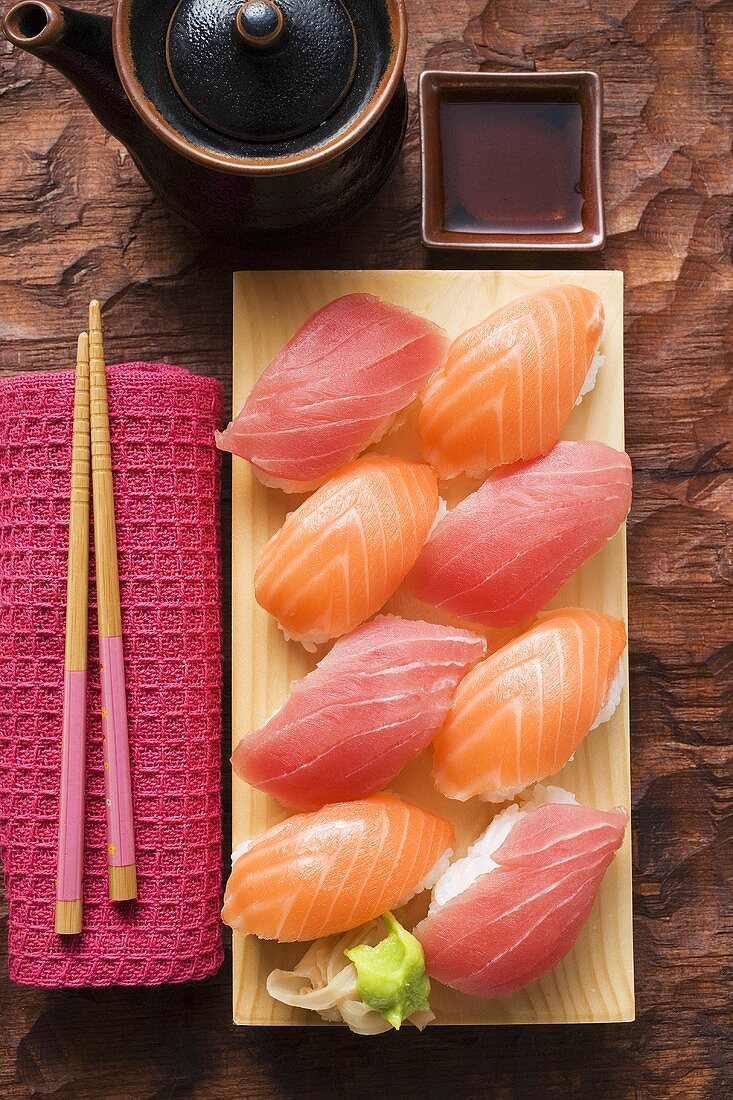 Nigiri sushi with tuna and salmon on sushi board