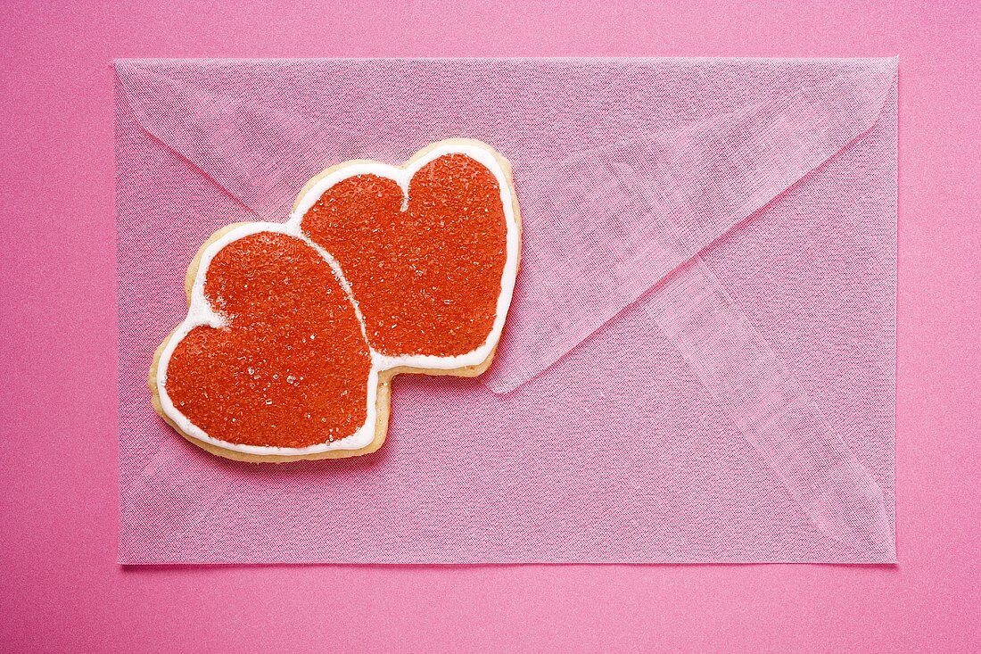 Pink envelope with red double heart-shaped biscuit