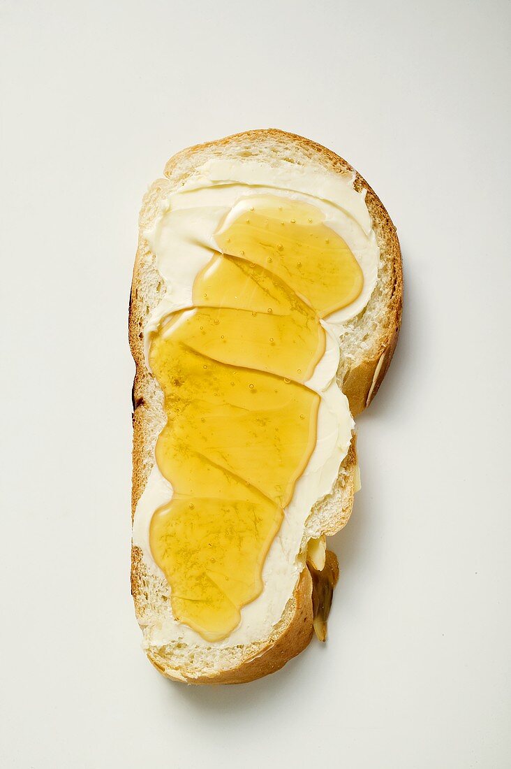 Slice of bread plait with butter and honey