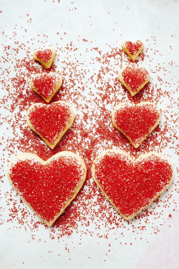 Eight heart-shaped biscuits decorated with red sugar