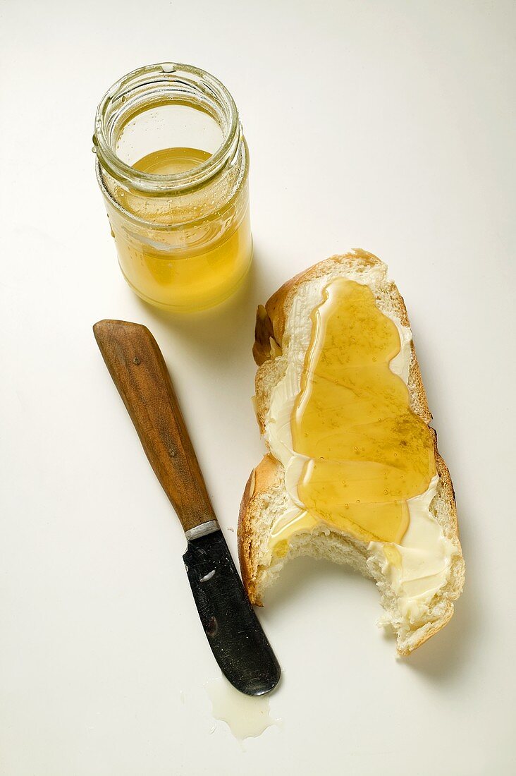 Angebissene Hefezopfscheibe mit Butter und Honig