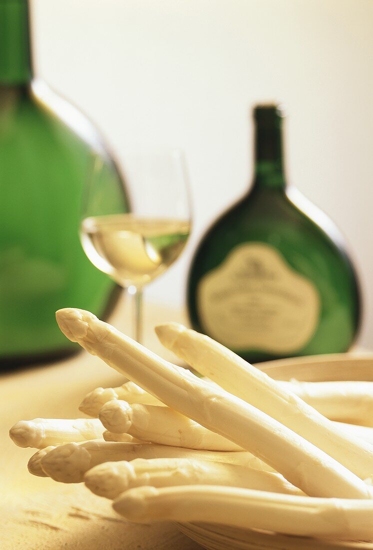 White asparagus spears, glass of white wine & Bocksbeutel