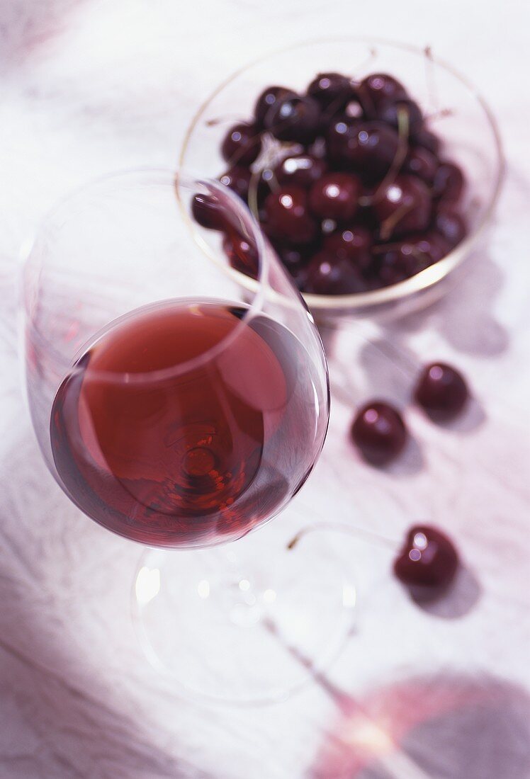 Glass of red wine and cherries