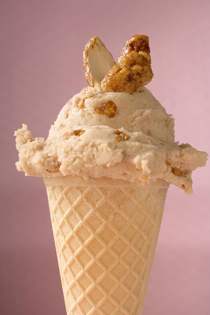 Ice cream with caramelised nuts in waffle cone