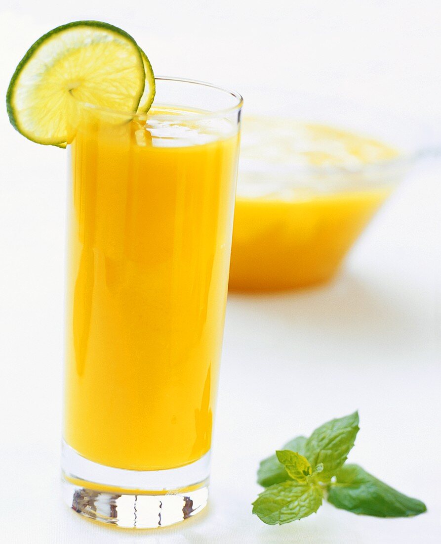 Orange juice garnished with slices of lime