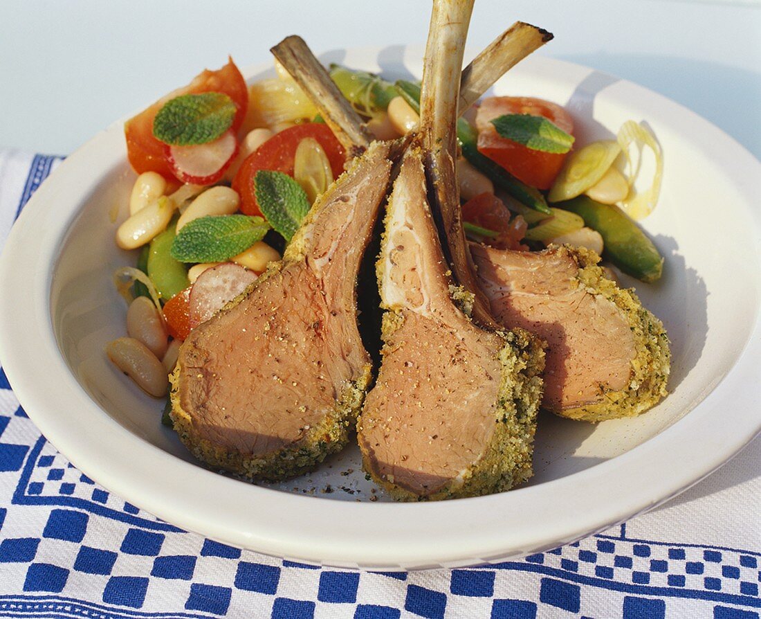 Lamb cutlets with herb crust and bean and tomato salad