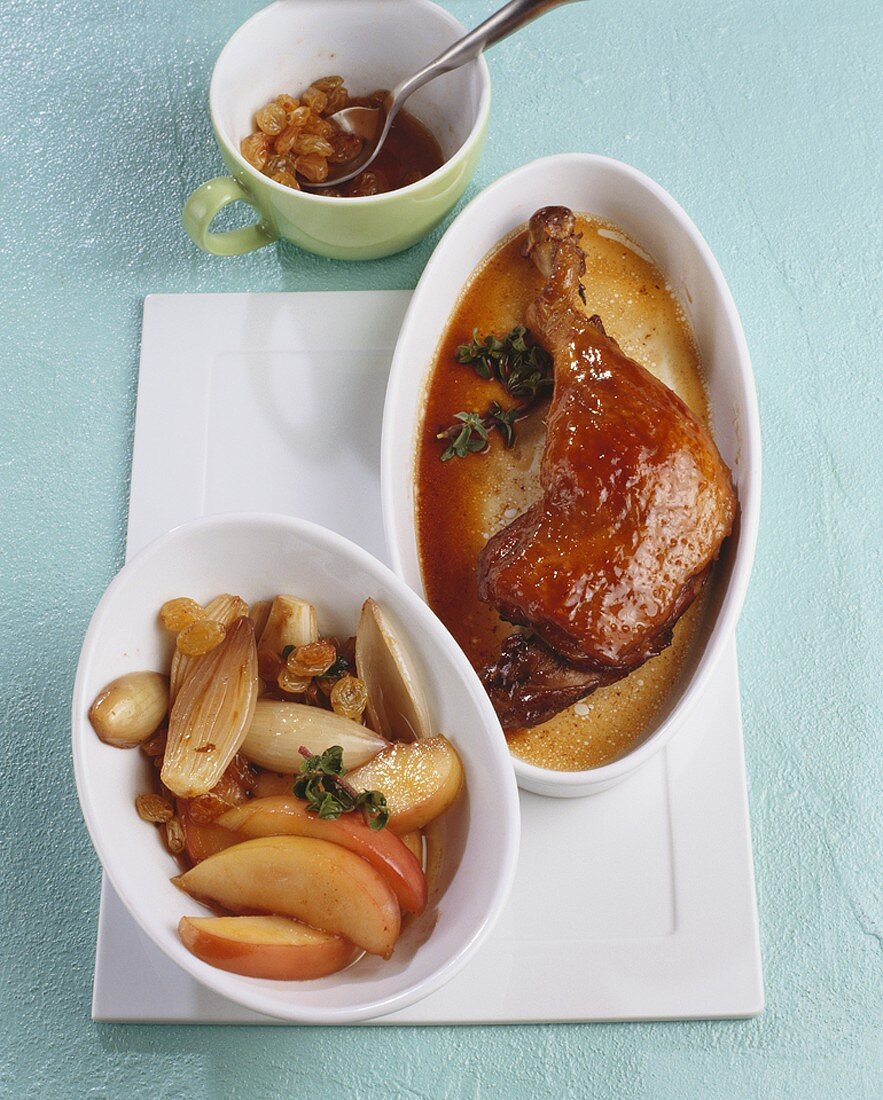 Duck leg with sultanas, apples and onions