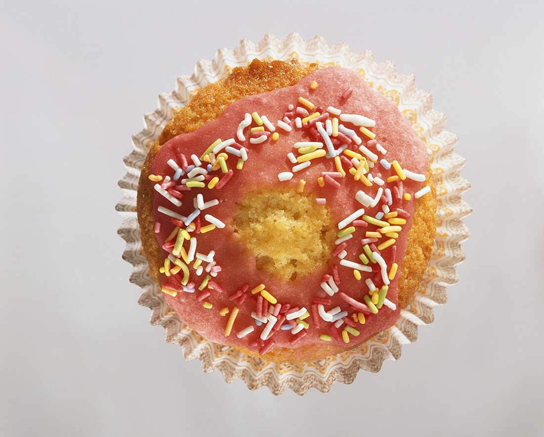 Muffin with pink icing and sprinkles