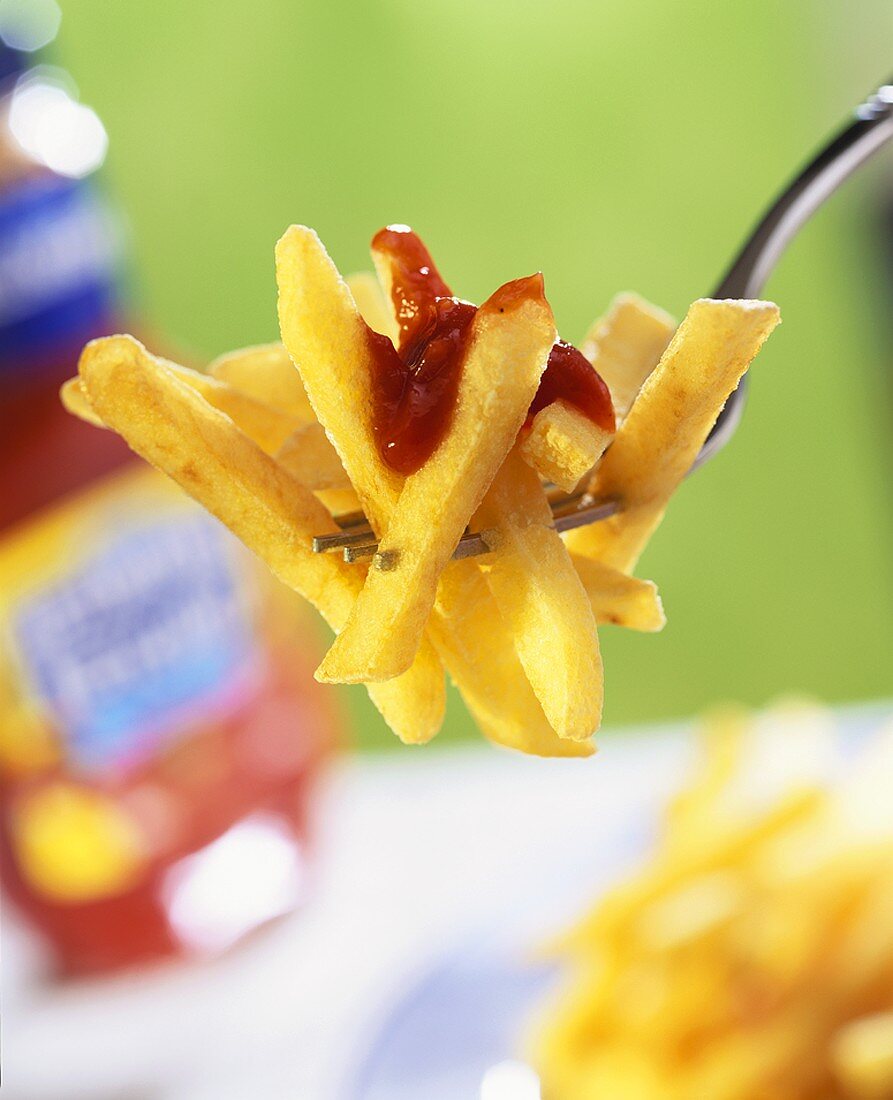 Chips with ketchup on fork