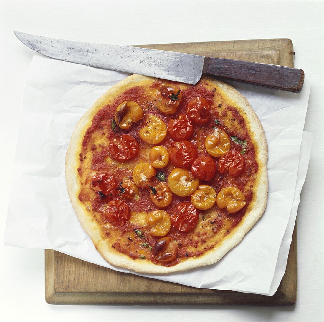 A tomato pizza (with cocktail tomatoes)