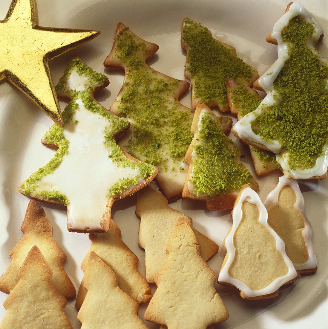 Biscuits in shape of Christmas trees with icing & pistachios