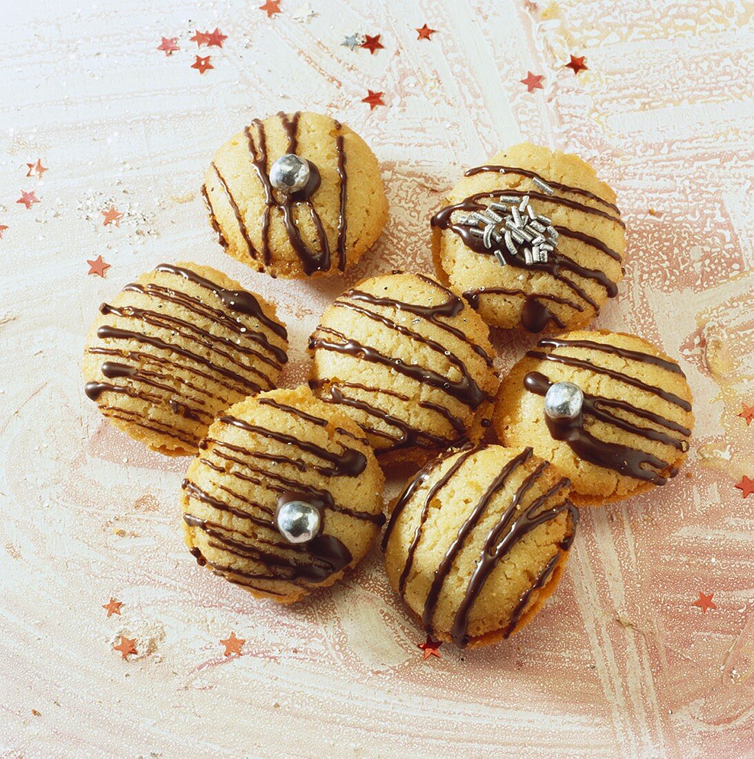 Biscuits with chocolate drizzle and silver pearls