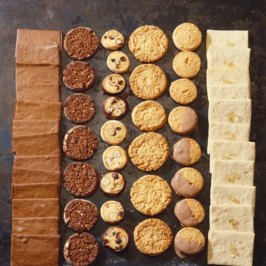 Christmas biscuits in rows on a baking sheet