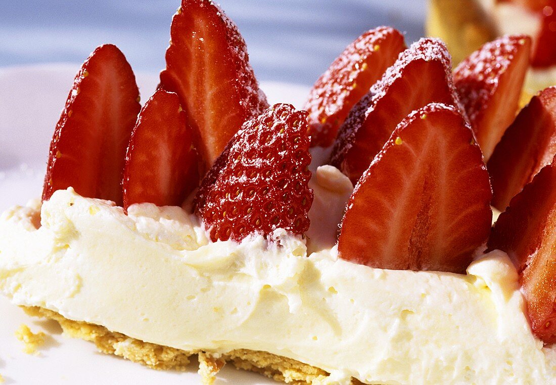 A piece of fresh strawberry cheesecake