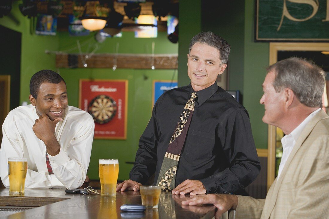 Drei Männer an der Bar in einem Pub