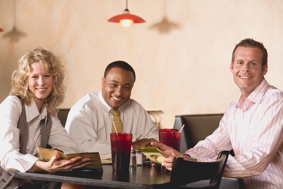 Three people at table in a restaurant