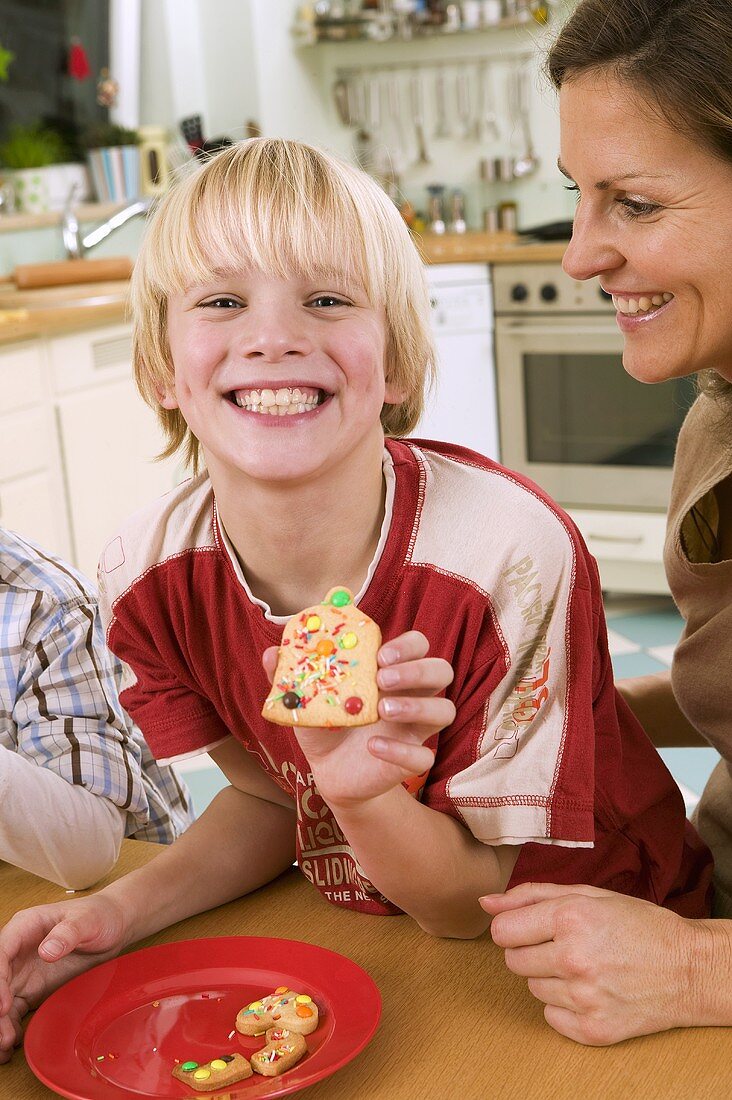 Boy showing a biscuit he made himself
