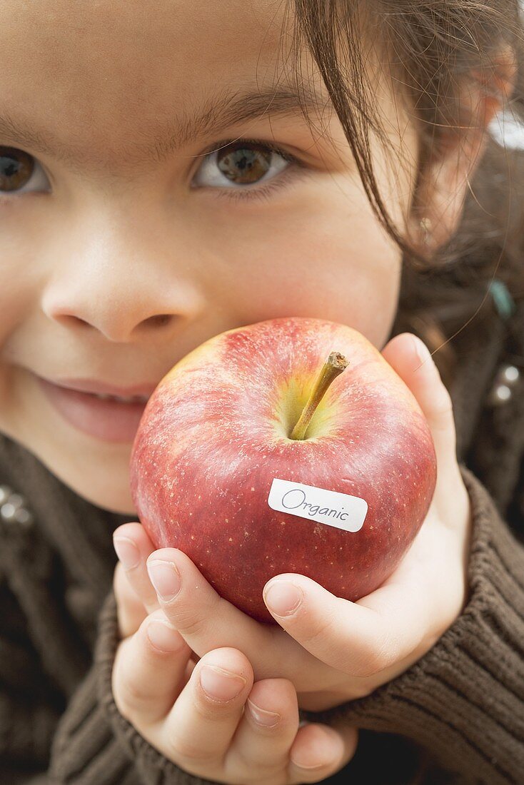 Girl with an organic apple