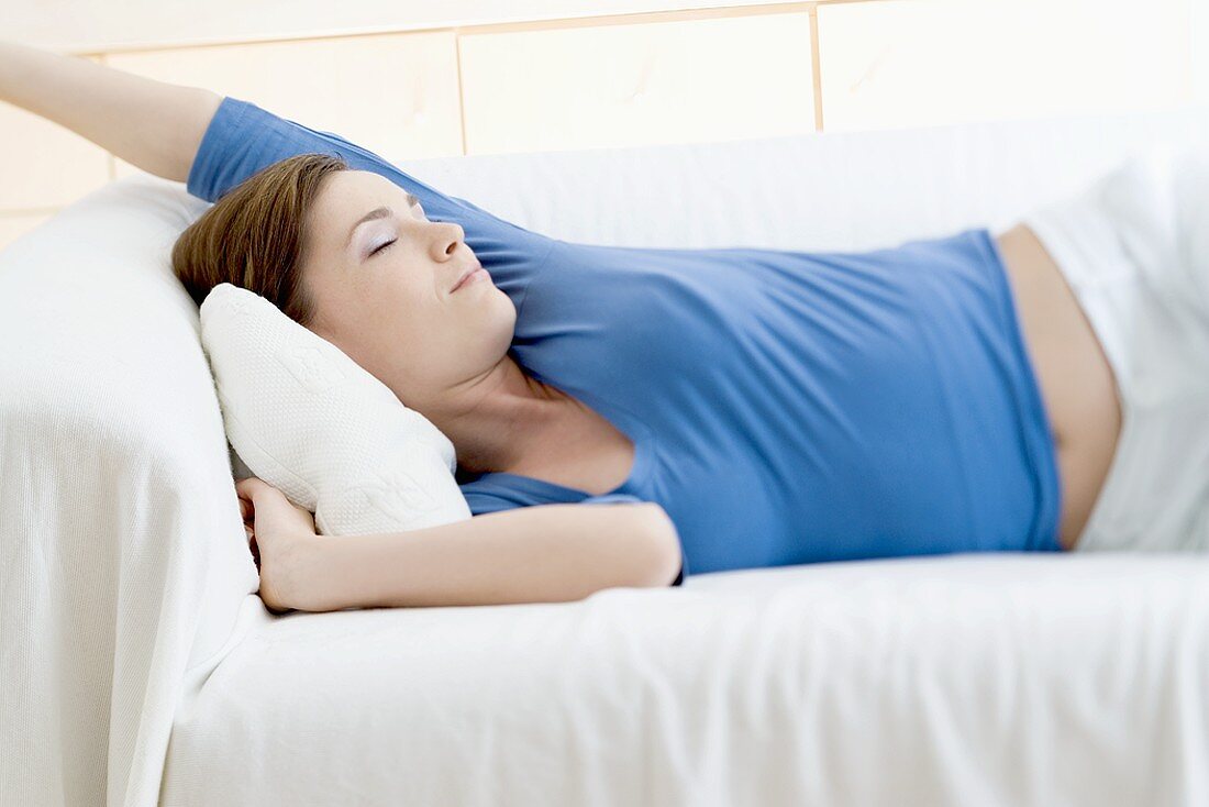 Young woman asleep on a sofa