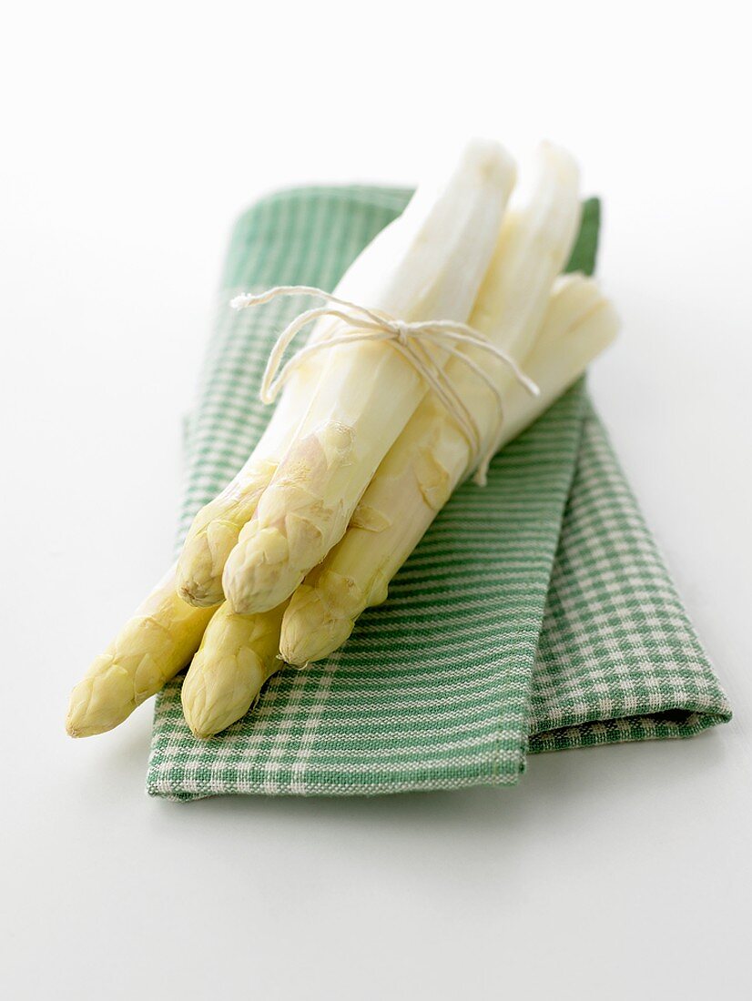 White asparagus on green checked cloth
