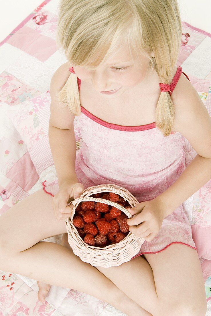 Blond girl with fresh raspberries (from above)
