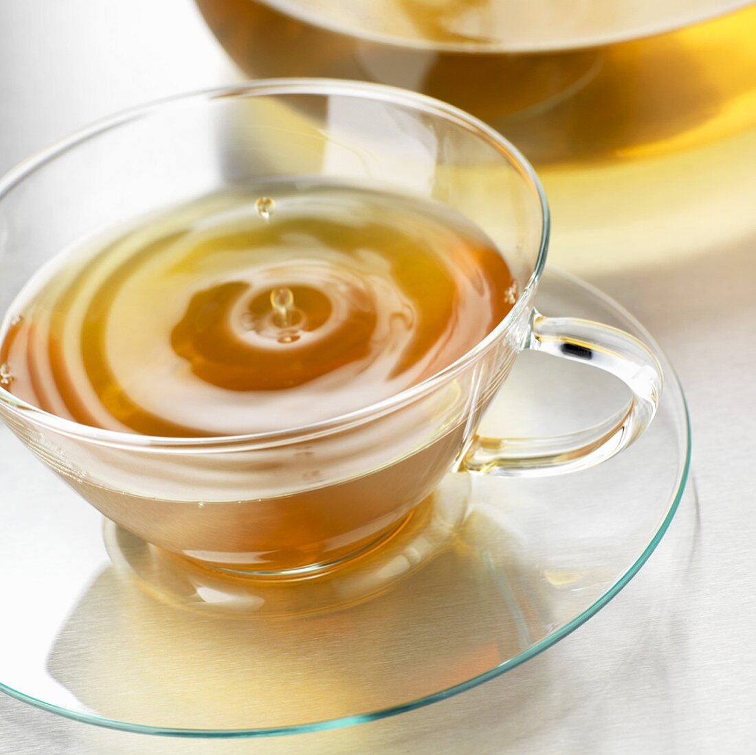 Drop of tea falling into a cup of tea