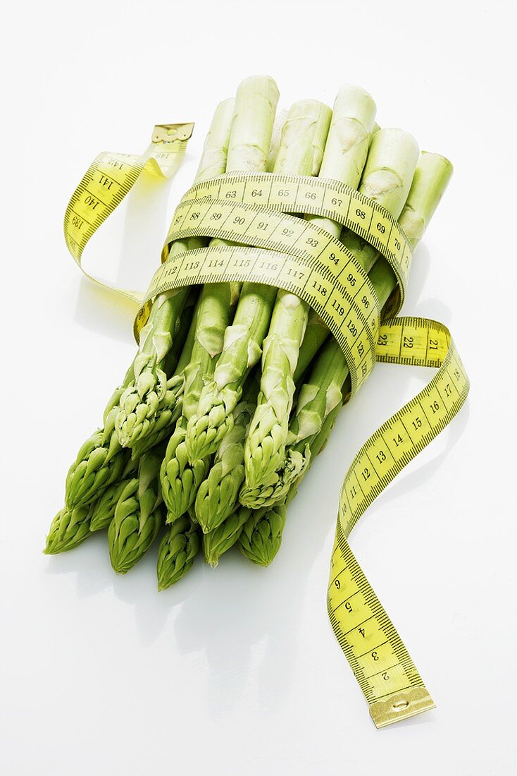 Green asparagus with a tape measure