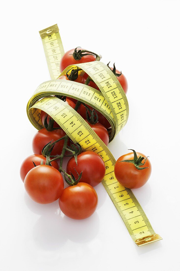 Cocktail tomatoes with a tape measure