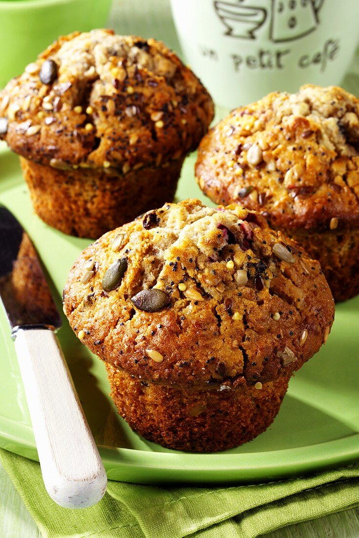 Three muffins with fruit and seeds