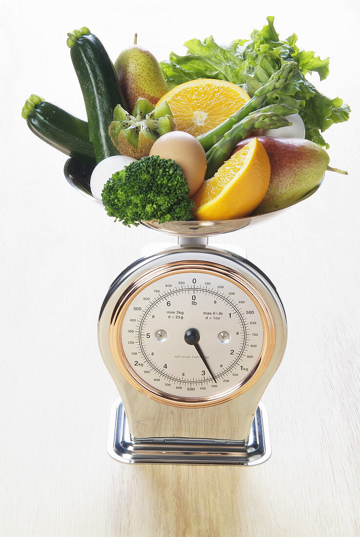 Fresh fruit, vegetables and eggs on scales