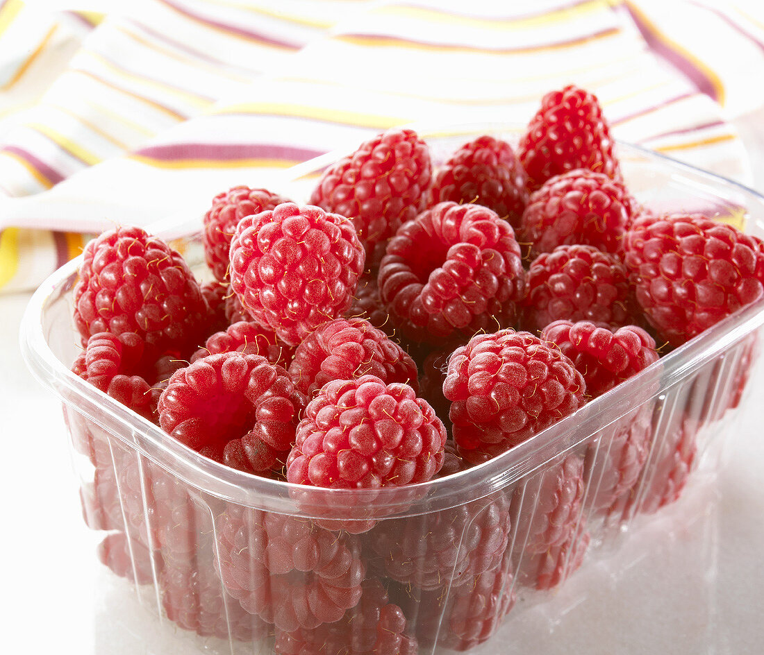 Fresh raspberries in a plastic punnet