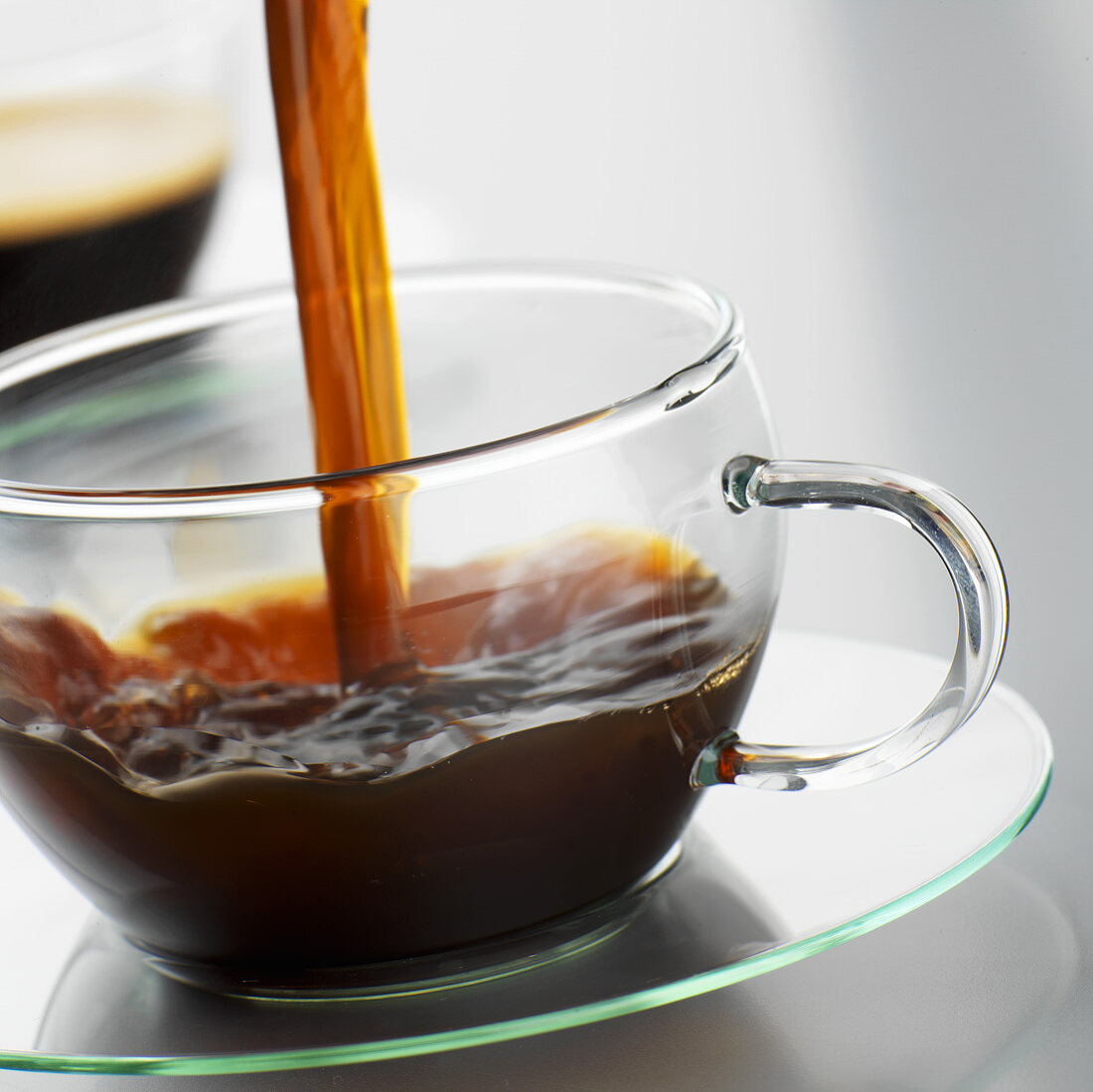 Pouring coffee into a glass cup