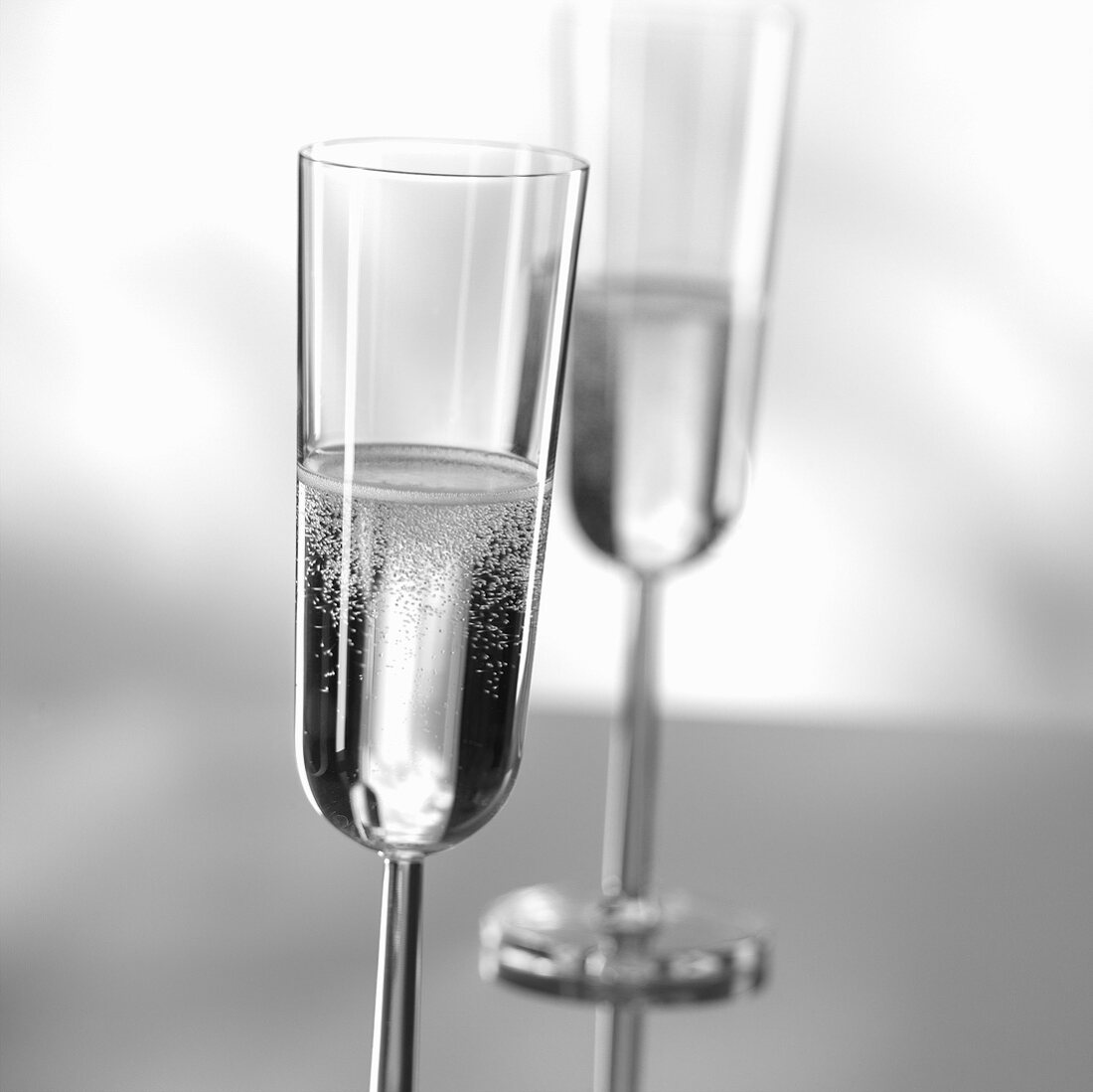 Two glasses of sparkling wine (black and white photo)