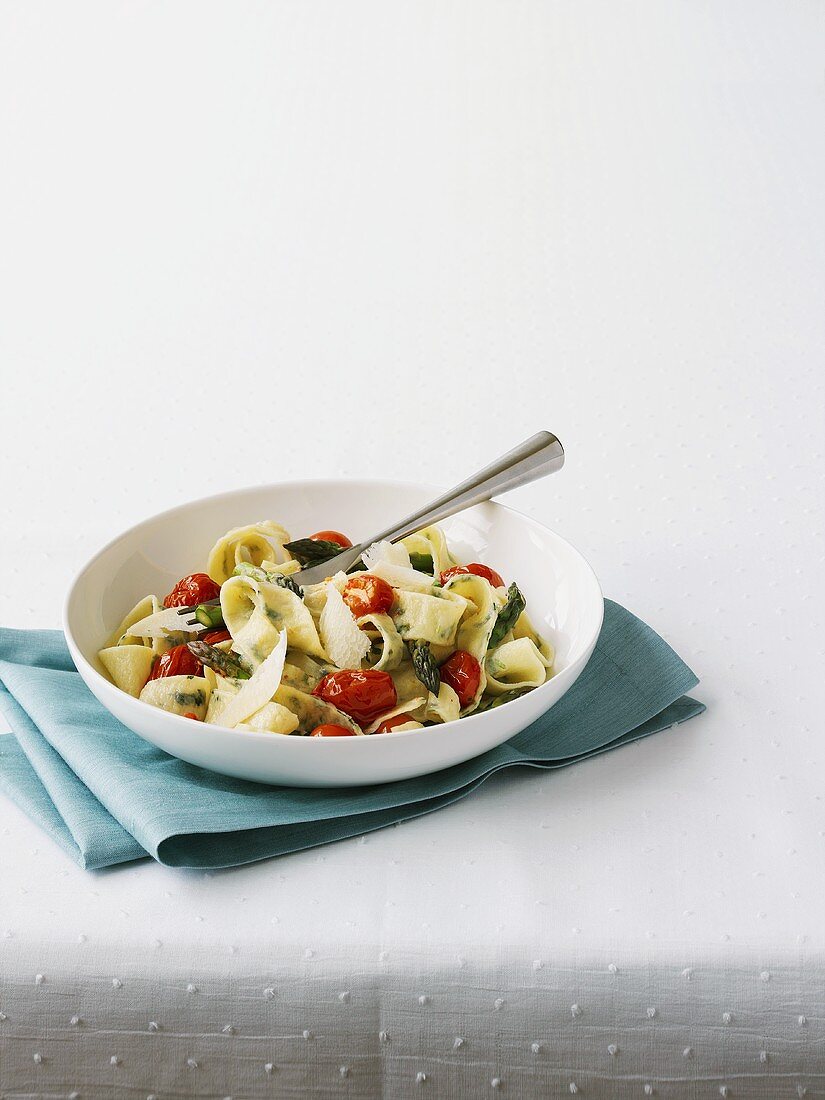Ribbon pasta with green asparagus and cocktail tomatoes