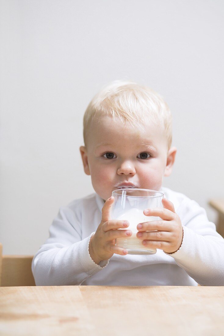 Kleiner Junge trinkt Milch