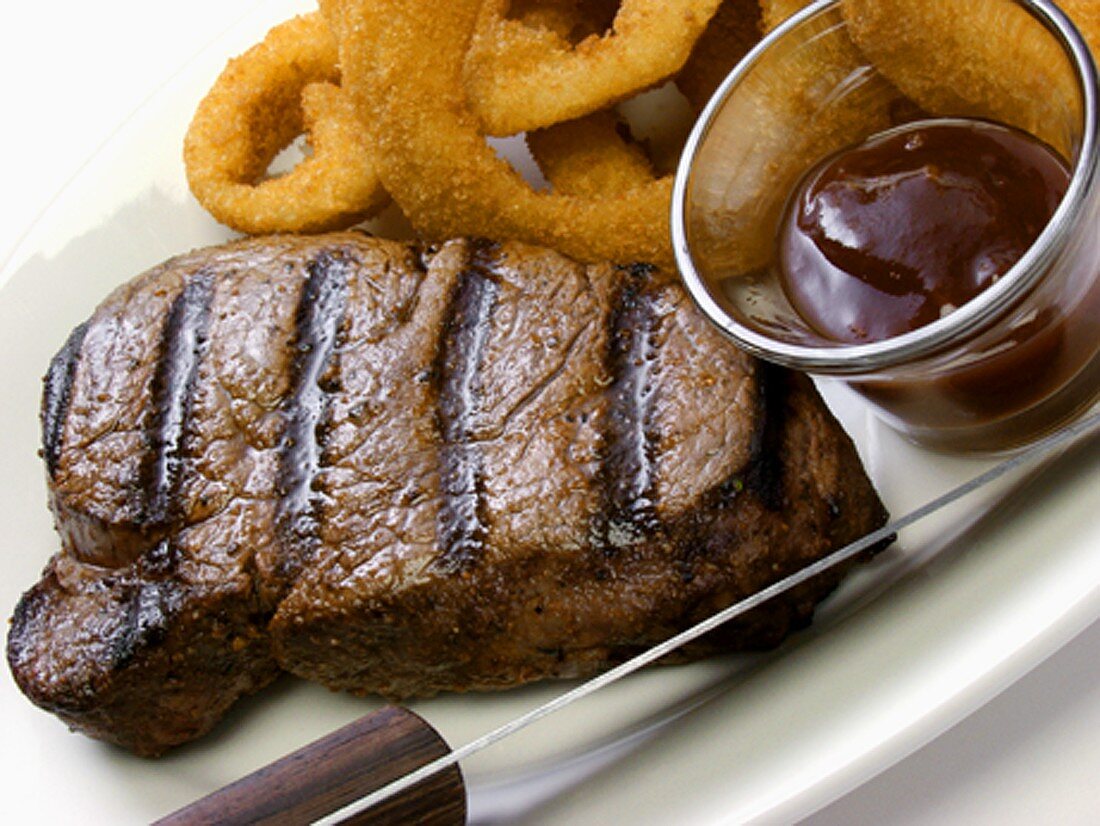 Rib Eye Steak with Onion Rings and Sauce