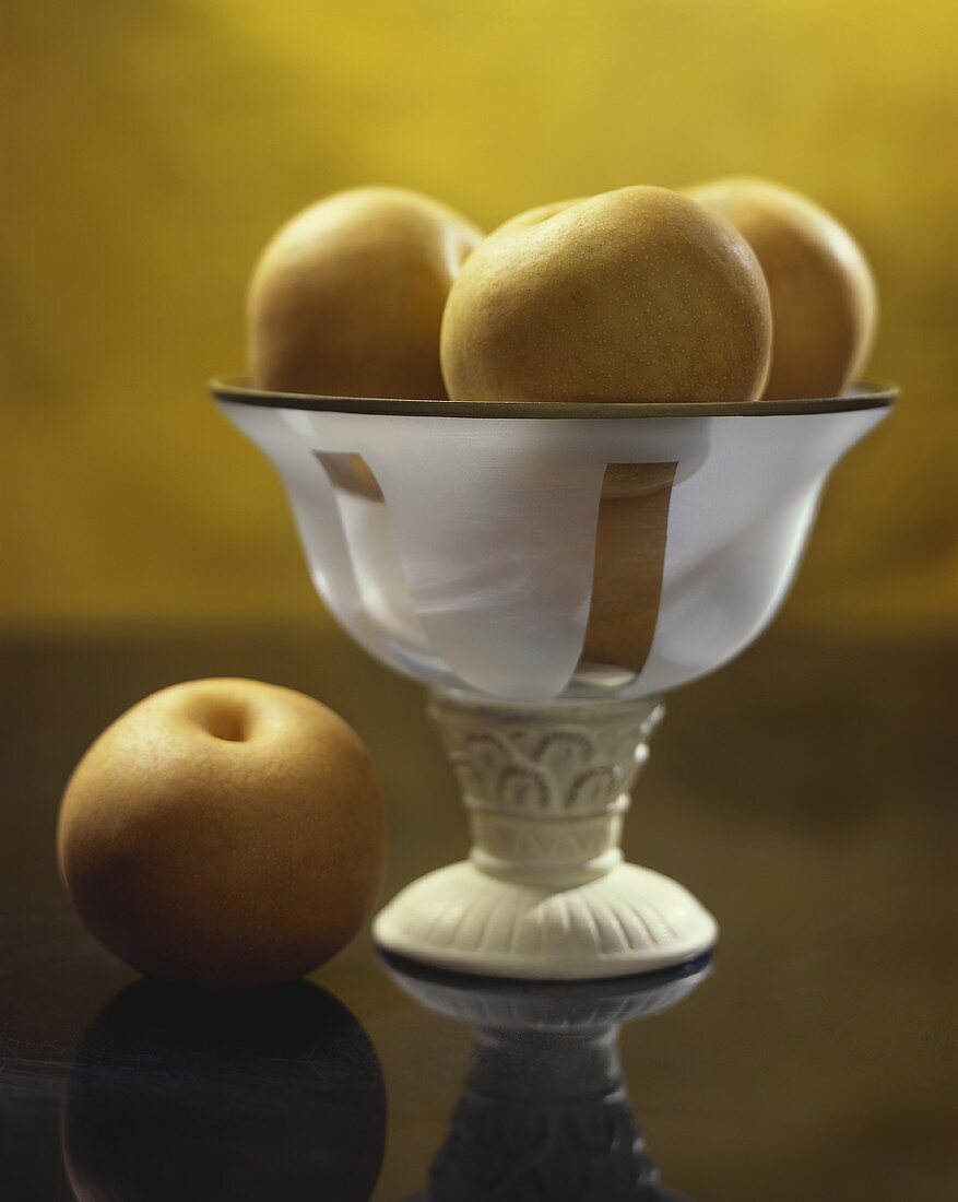 Nashi pears in and beside a fruit bowl