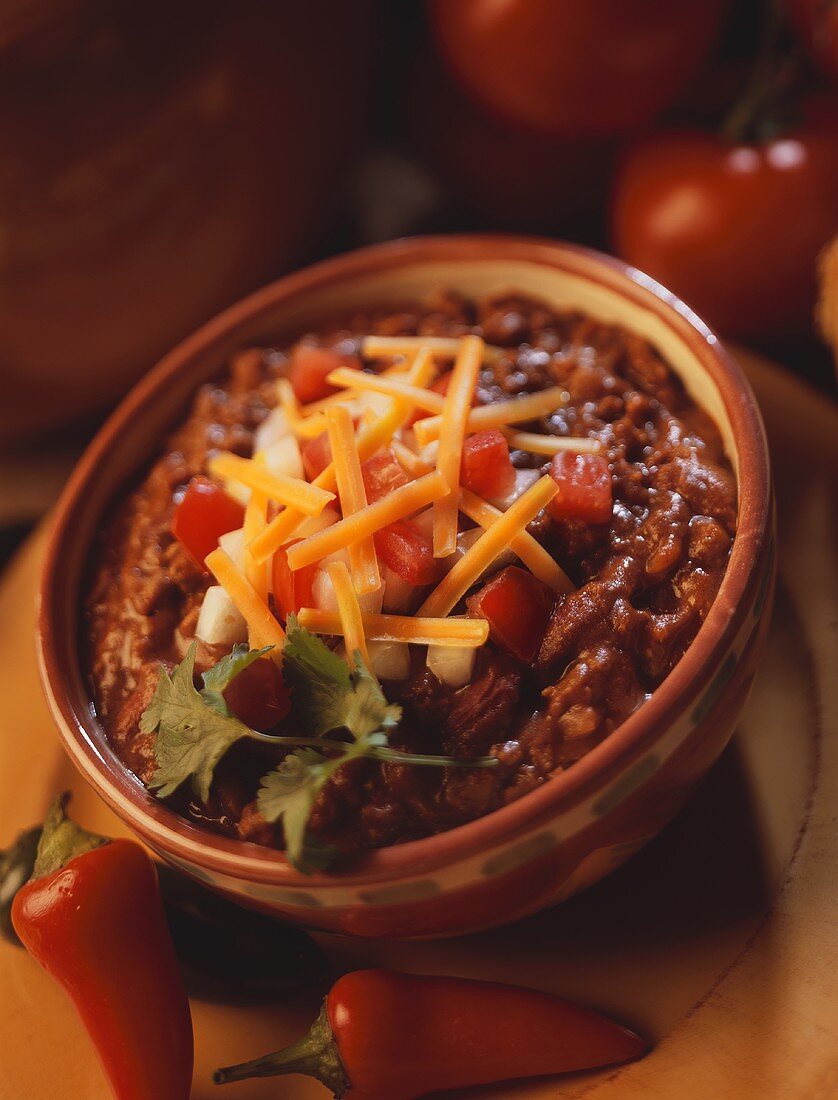 Bowl of Chili Topped with Salsa and Cheese
