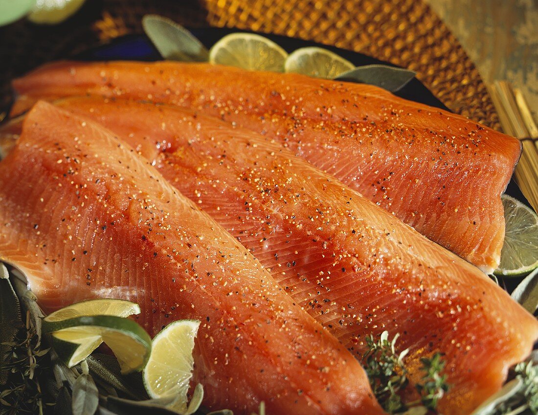 Three Salmon Fillets on a Platter with Limes