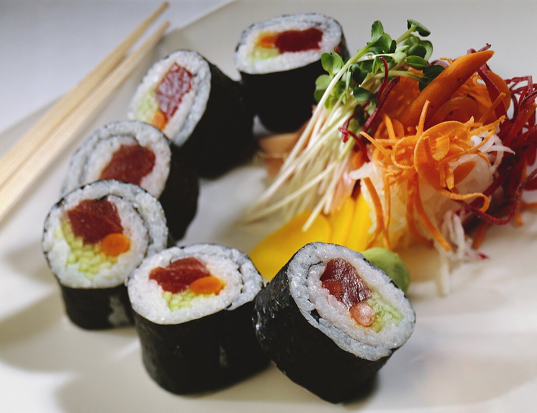 Sliced Sushi Roll with Veggies and Chopsticks