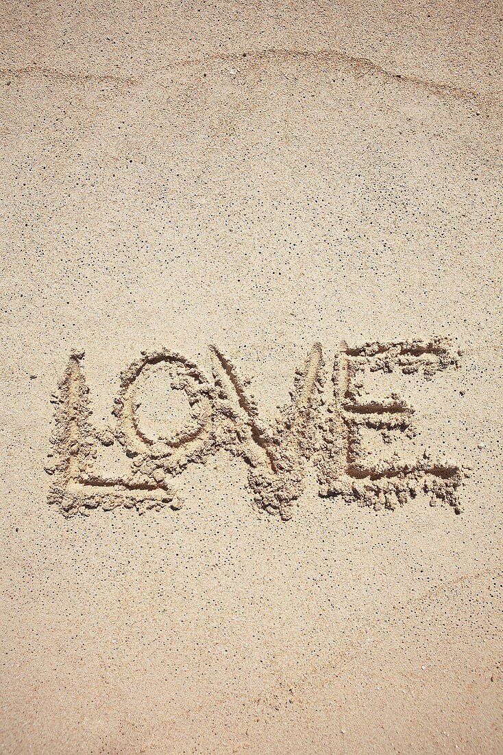 The word LOVE written in sand