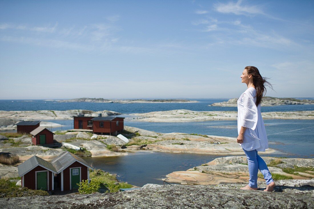 A woman on a rocky beach in Scandinavia